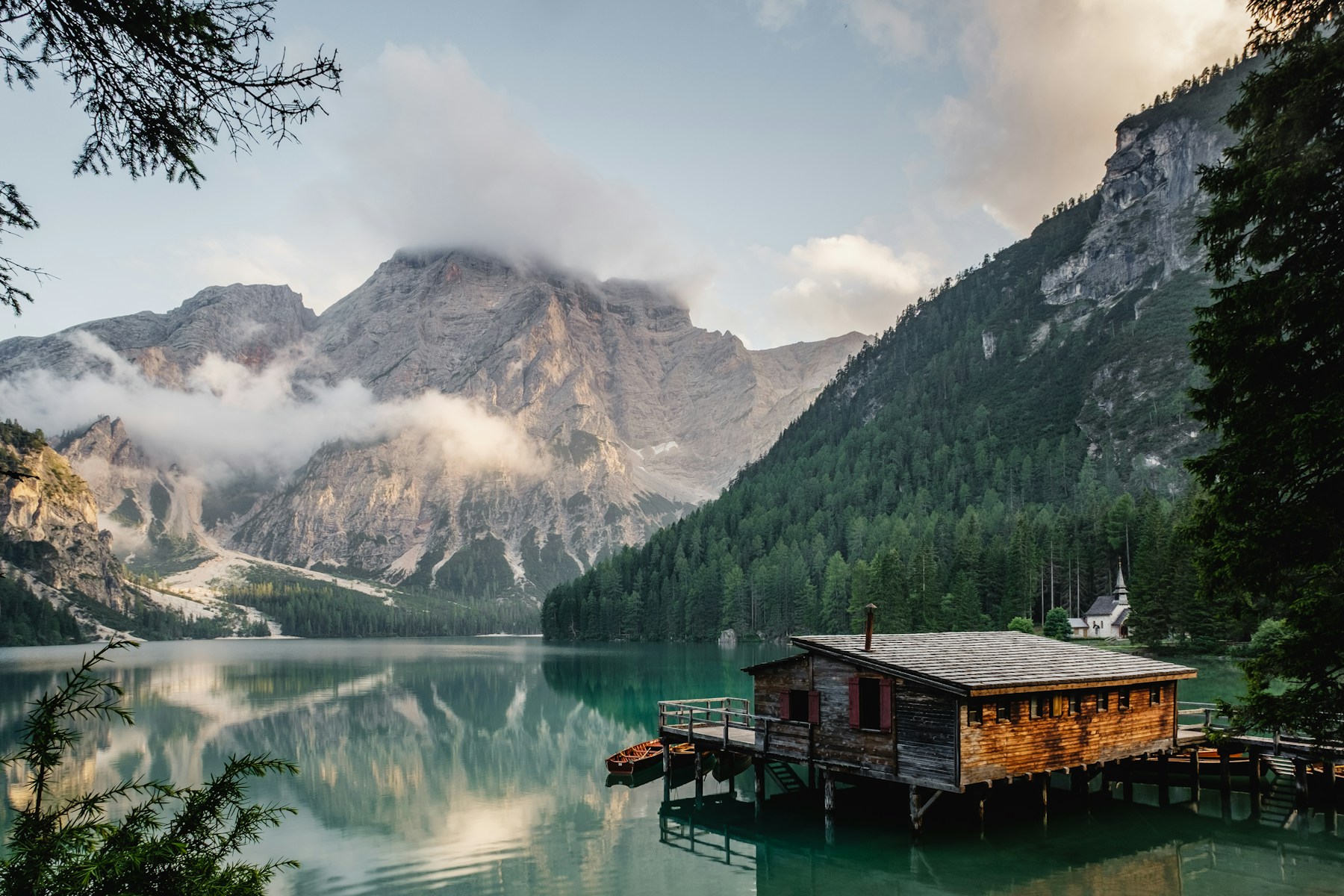 Alpine mountains reflected in a forest lake